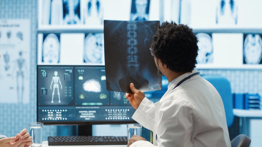 A consultant reviewing a diagnostic scan on screen